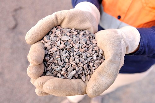 Hands holding Easy Drain gravel for drainage solutions