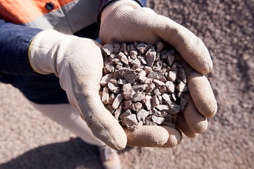 Hands displaying Engineered Fill aggregate product