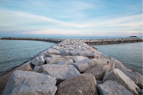 Armour rock along a coastal barrier