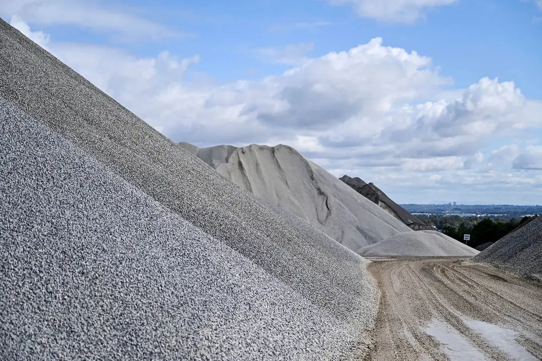 Stockpile of coarse aggregate rocks at a quarry site, used for construction, drainage and infrastructure projects.