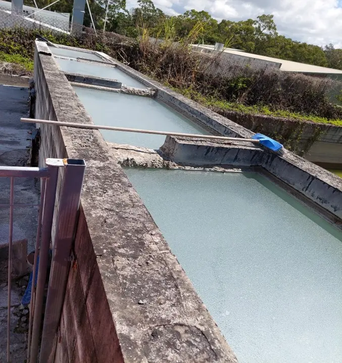 Water management infrastructure at the Heidelberg Materials Australia Southport Concrete Plant, featuring settling ponds used for water recycling and site water treatment processes.