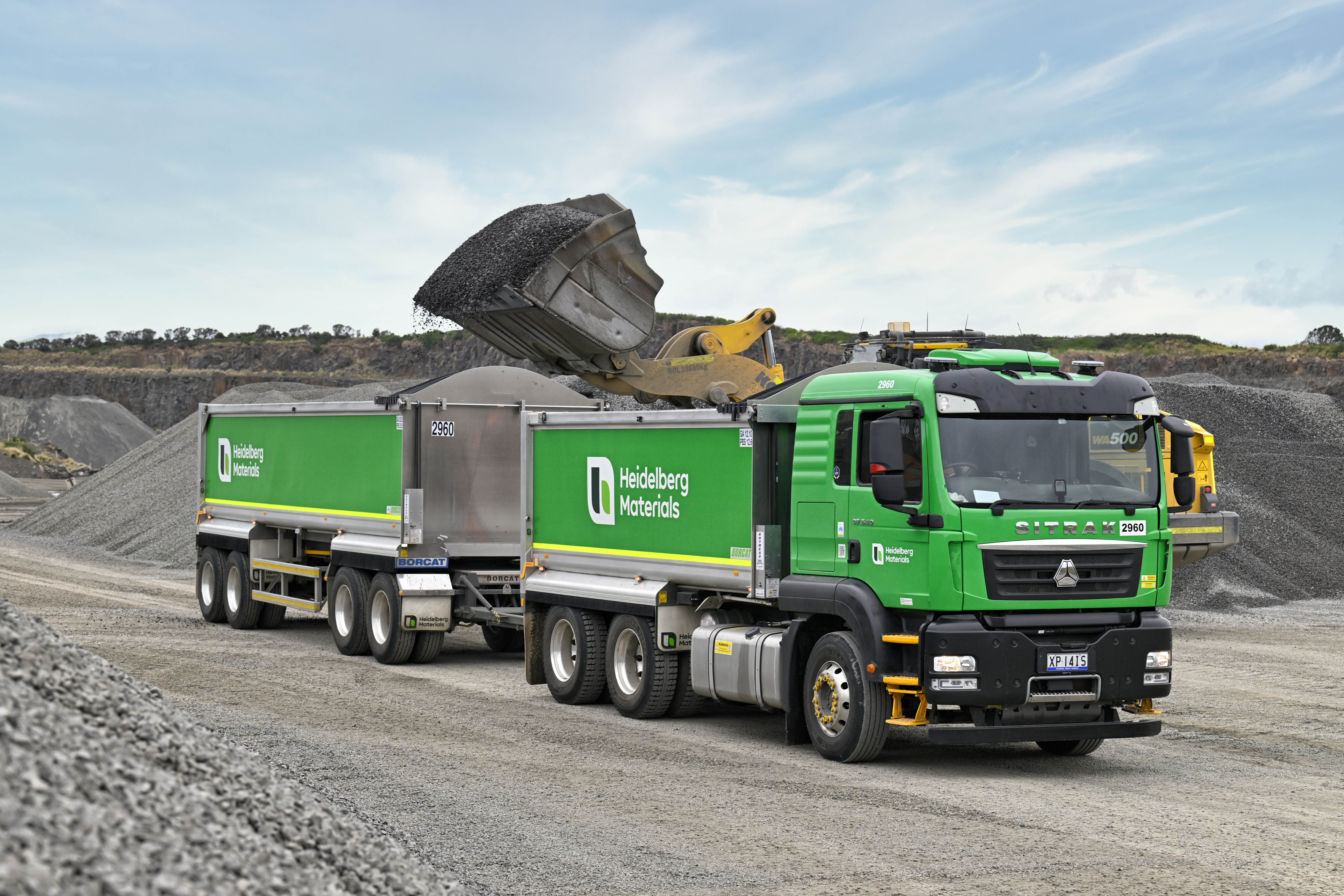 Heidelberg Materials Australia aggregate truck and trailer being loaded with aggregate and quarry material