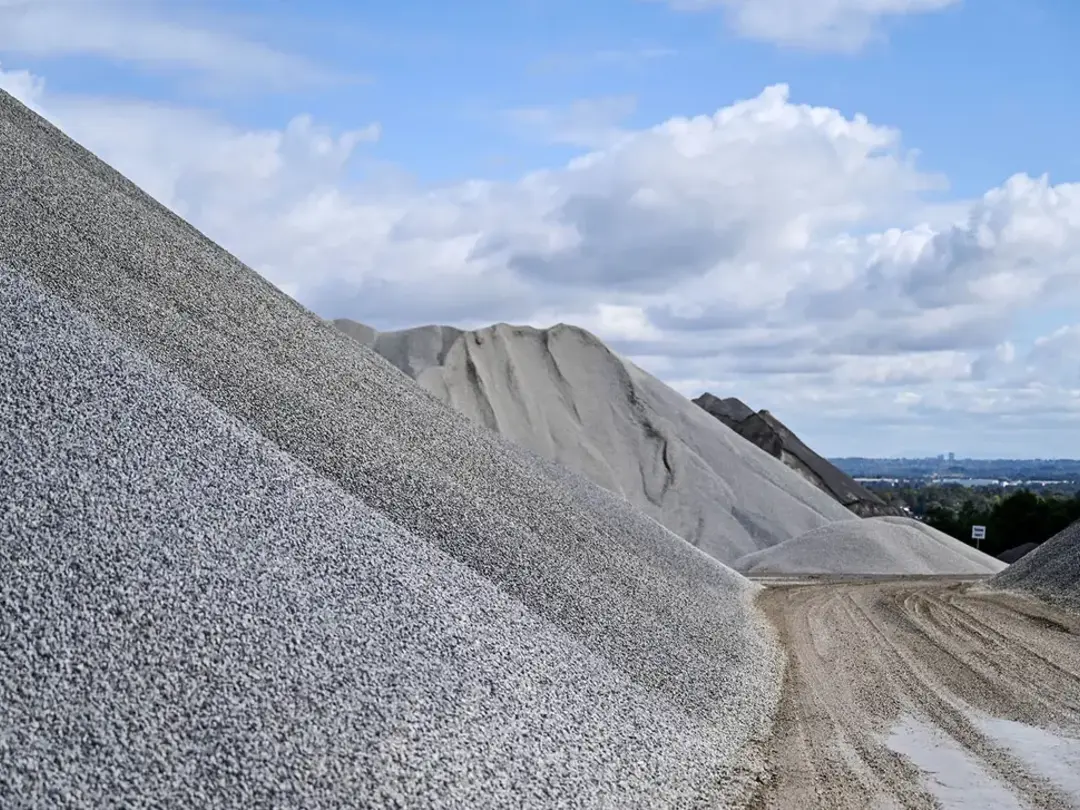 Stockpile of coarse aggregate rocks at a quarry site, used for construction, drainage and infrastructure projects.