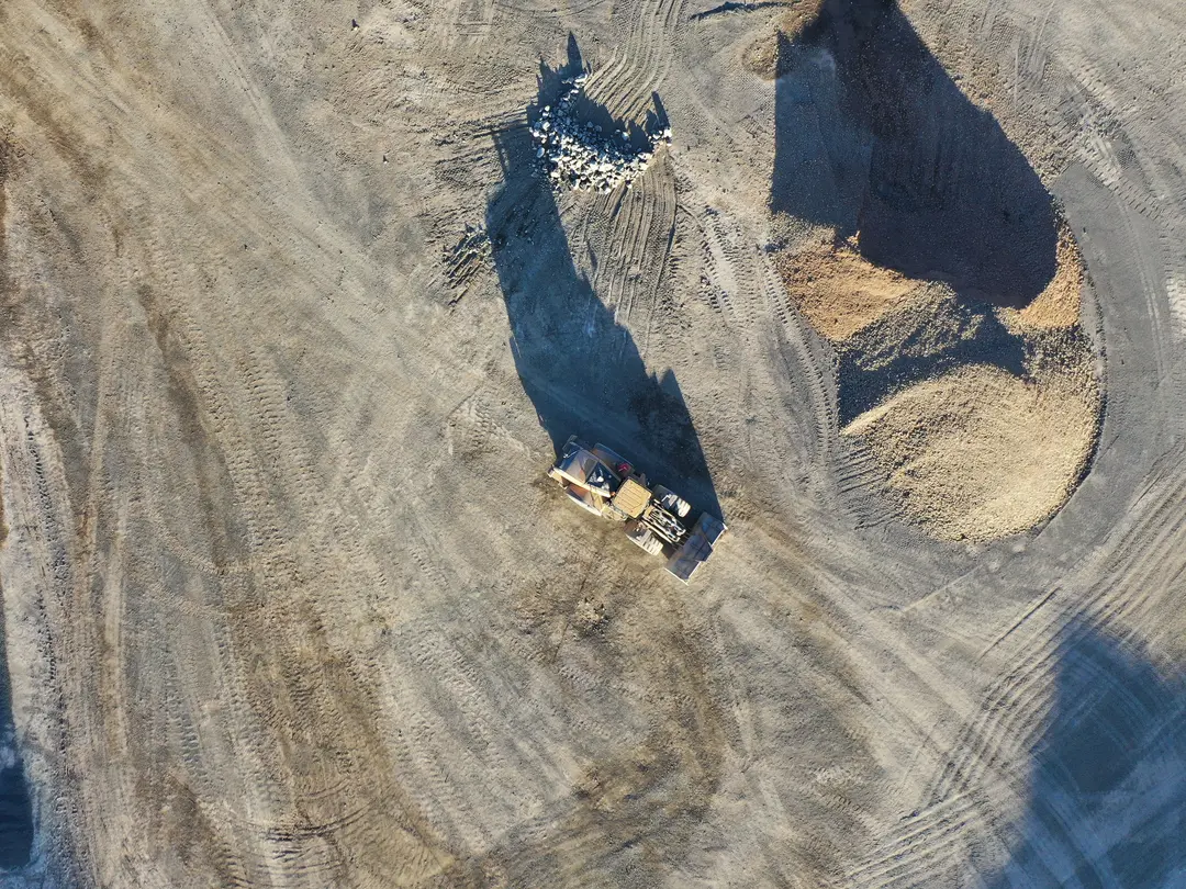 Fill material and yellow truck at Heidelberg Materials Australia quarry. 