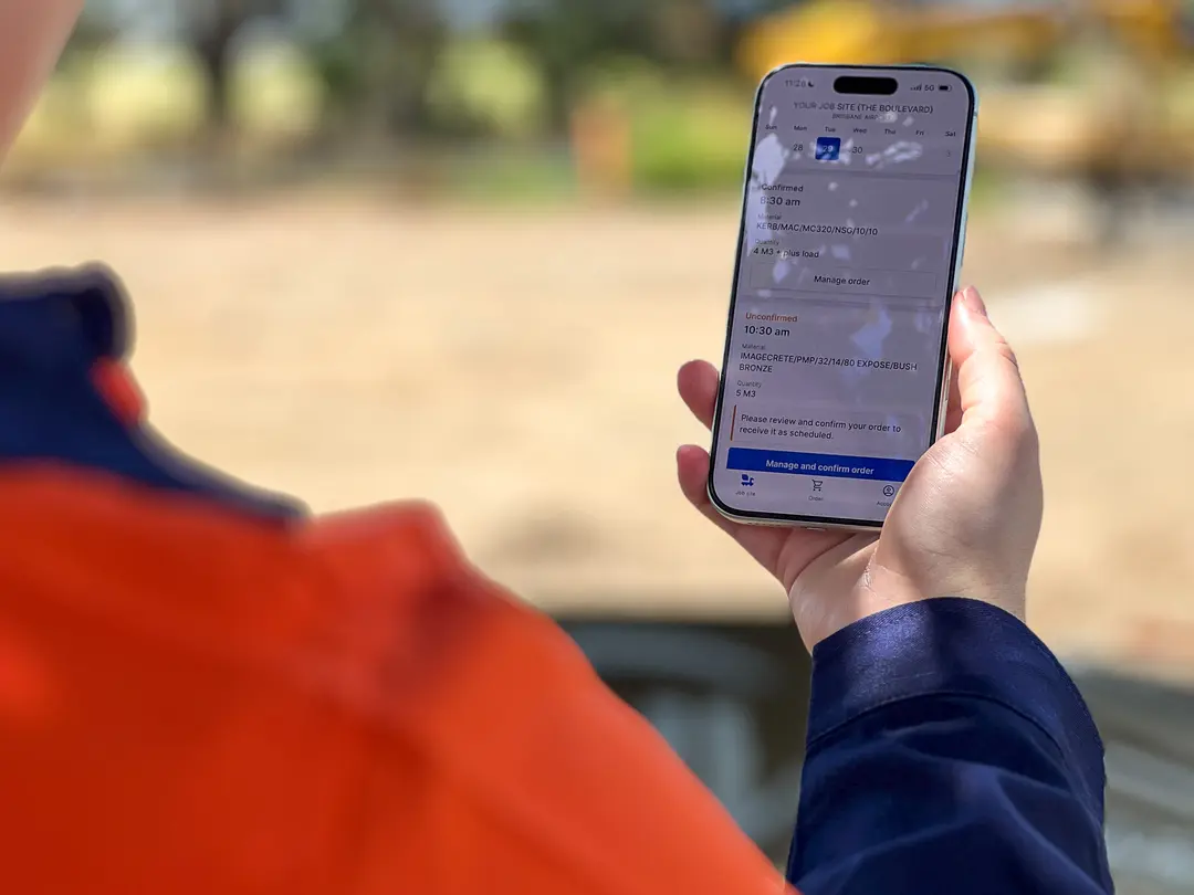 Construction worker using Heidelberg Materials OnSite app to review orders on the go. 