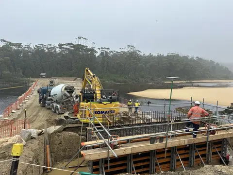 Hedielberg Materials Reconstruction works underway at Thurra Bridge following damage, with crews and heavy equipment working to restore the bridge infrastructure and surrounding access area.